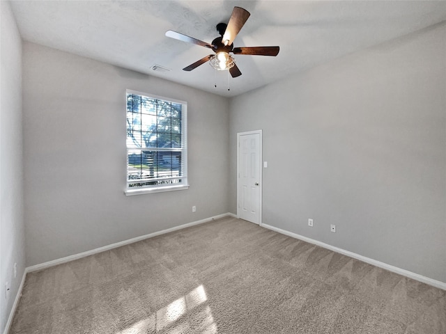 carpeted spare room featuring ceiling fan