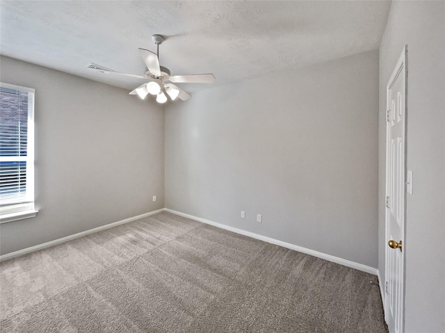 carpeted empty room with a textured ceiling and ceiling fan