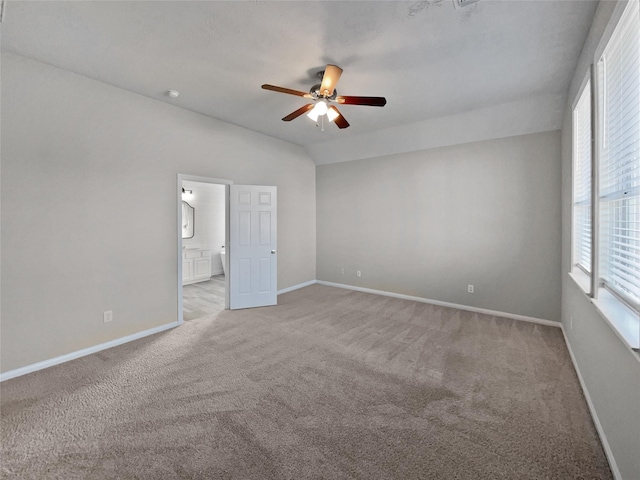 carpeted empty room featuring ceiling fan and lofted ceiling