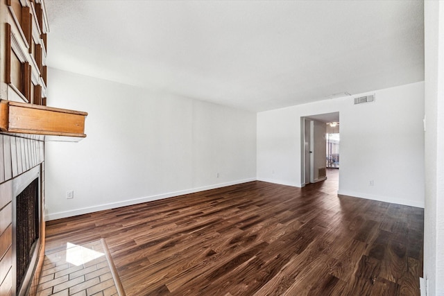 unfurnished living room featuring dark hardwood / wood-style flooring