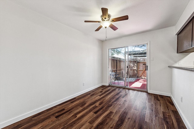 spare room with ceiling fan and dark hardwood / wood-style floors