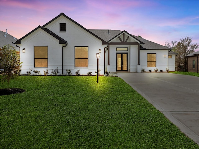 modern farmhouse featuring a yard and french doors