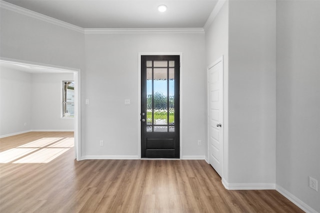 foyer with light hardwood / wood-style floors and ornamental molding