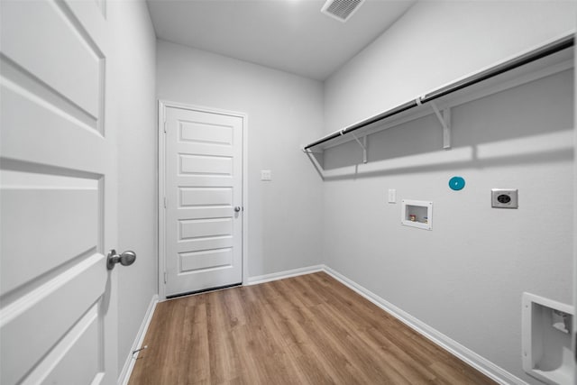 laundry room featuring washer hookup, light wood-type flooring, hookup for a gas dryer, and hookup for an electric dryer