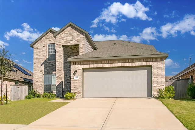 view of front of home featuring a garage and a front lawn