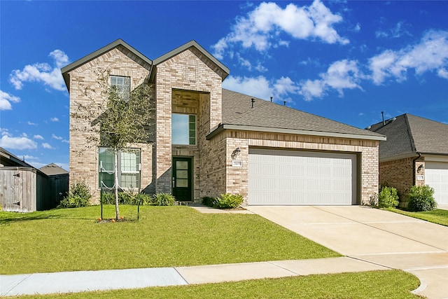 view of front of property featuring a garage and a front lawn