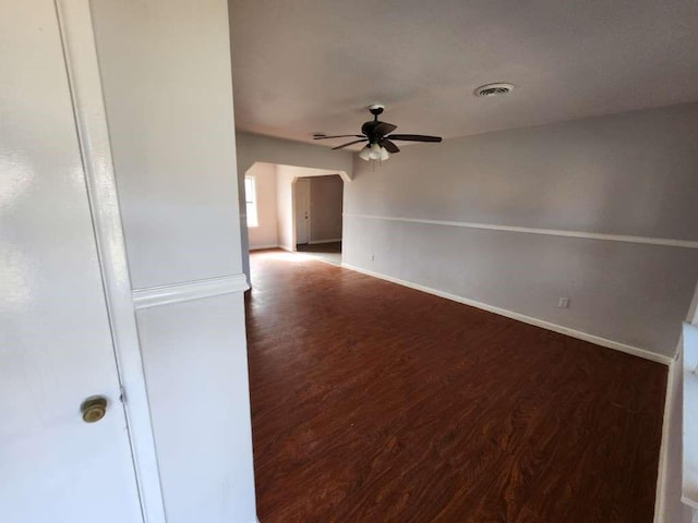 unfurnished room featuring ceiling fan and dark wood-type flooring