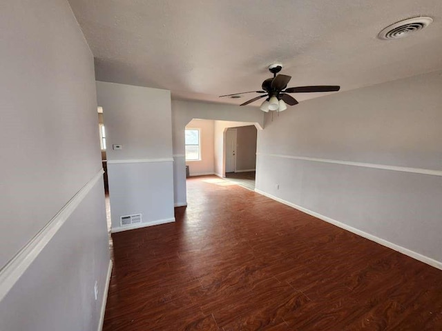 empty room featuring dark hardwood / wood-style flooring and ceiling fan