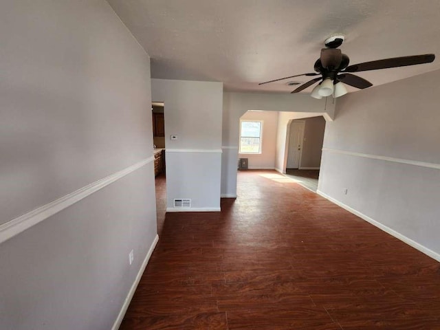 empty room featuring ceiling fan and dark wood-type flooring