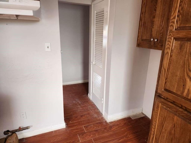 corridor with dark hardwood / wood-style floors