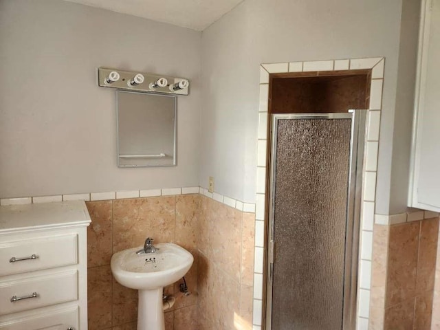 bathroom featuring an enclosed shower and tile walls