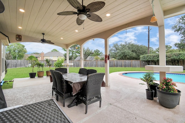 view of patio / terrace with ceiling fan and a fenced in pool