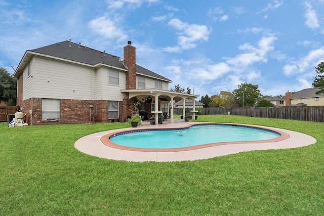 view of swimming pool featuring a patio area and a yard