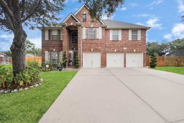 view of front facade with a front yard and a garage