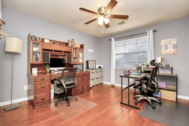 office area with ceiling fan and light hardwood / wood-style floors