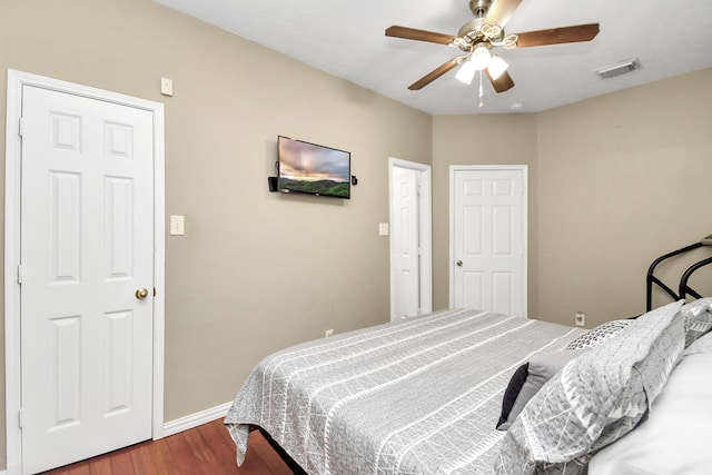 bedroom with ceiling fan and wood-type flooring