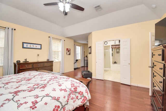 bedroom with ensuite bath, ceiling fan, and dark wood-type flooring