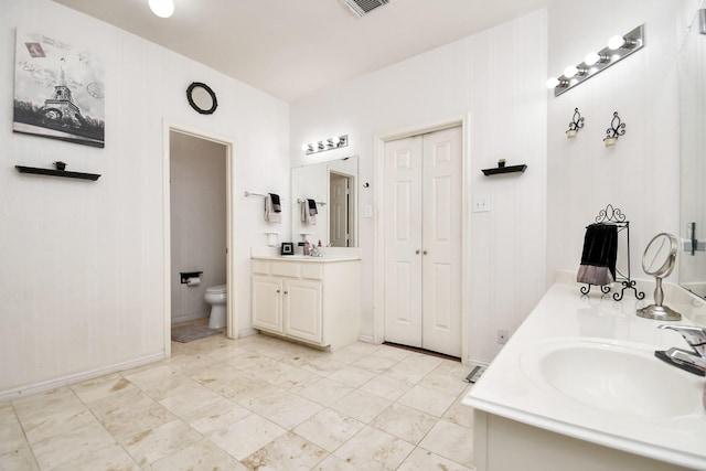 bathroom featuring vanity and toilet