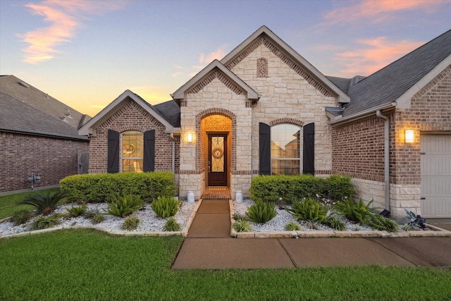 french provincial home featuring a yard