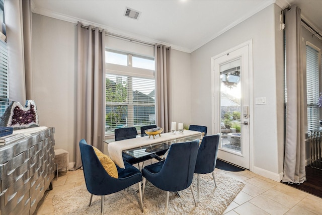 tiled dining space featuring ornamental molding