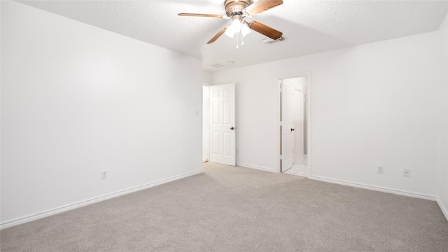 carpeted empty room with a textured ceiling and ceiling fan