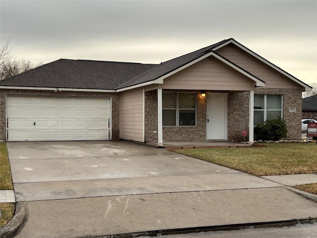 single story home featuring a garage and a yard