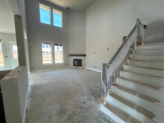 unfurnished living room with a high ceiling