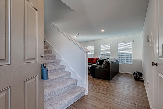 staircase with wood-type flooring