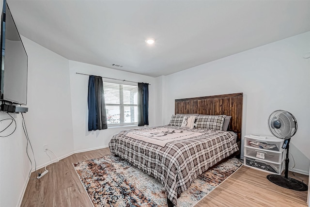 bedroom with hardwood / wood-style flooring