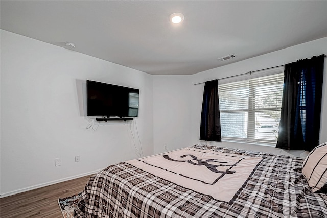 bedroom with hardwood / wood-style floors