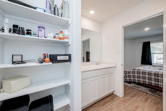 bathroom with vanity and hardwood / wood-style flooring