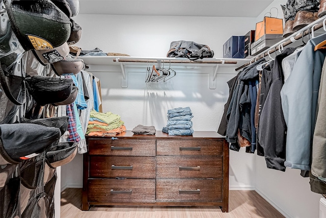 spacious closet with light hardwood / wood-style floors