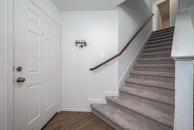 staircase with hardwood / wood-style flooring