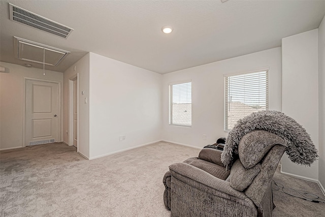 living area with light carpet