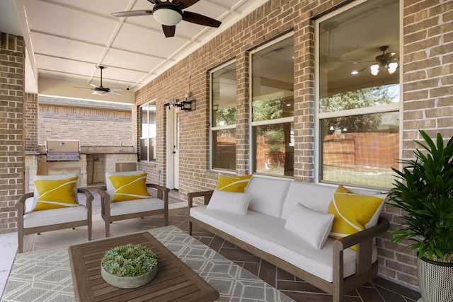 view of patio / terrace with a grill, ceiling fan, covered porch, and an outdoor kitchen