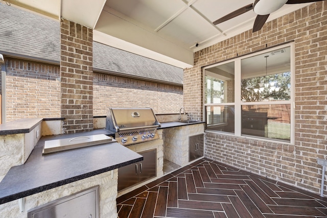 view of patio with a grill, ceiling fan, sink, and exterior kitchen