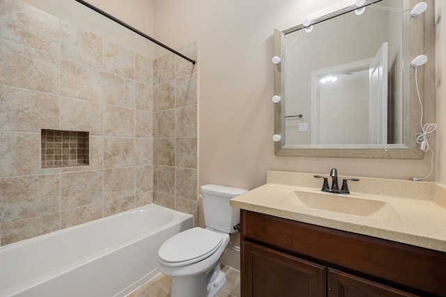 full bathroom featuring vanity, tiled shower / bath combo, and toilet