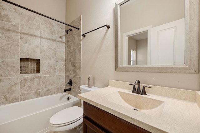 full bathroom featuring vanity, toilet, and tiled shower / bath