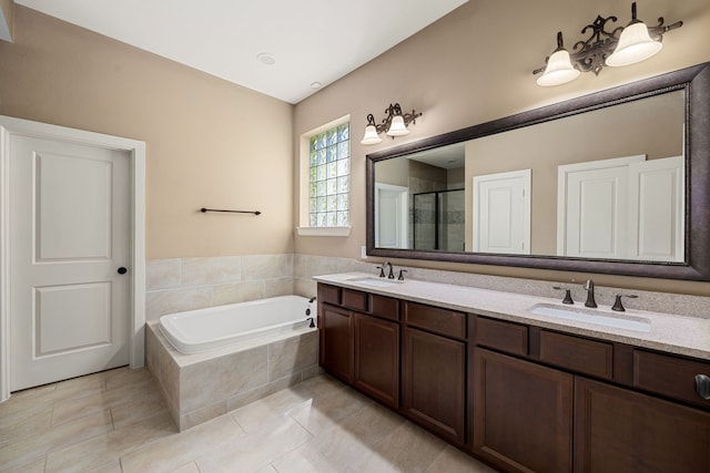 bathroom featuring tile patterned floors, vanity, and separate shower and tub