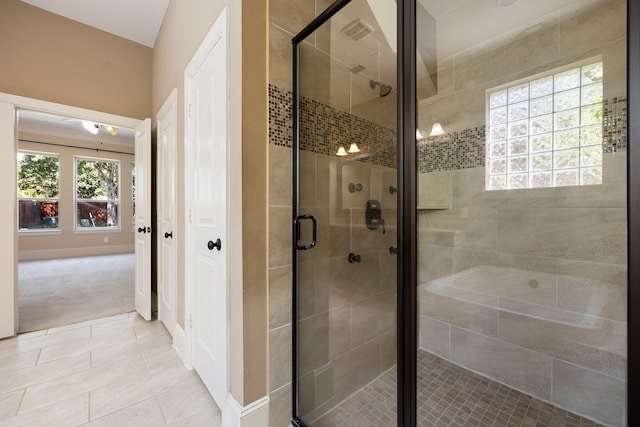 bathroom with a shower with door