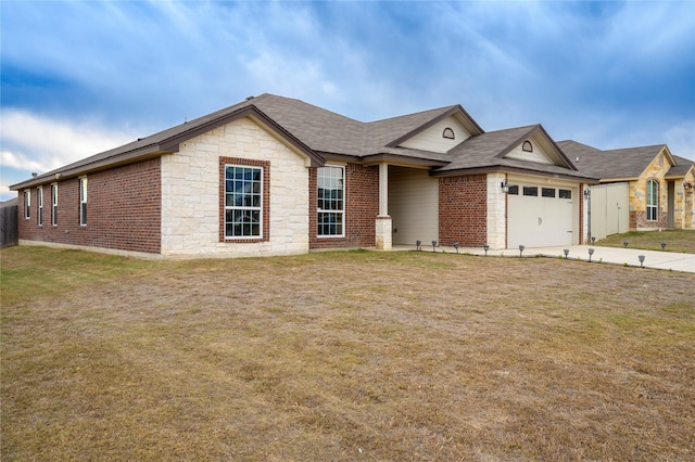 single story home featuring a front lawn and a garage