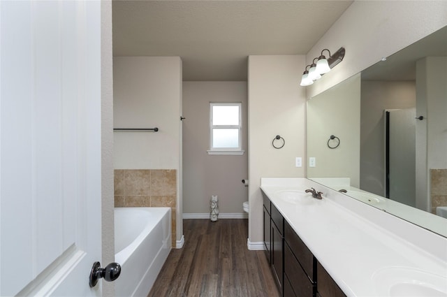 full bathroom featuring vanity, hardwood / wood-style flooring, separate shower and tub, toilet, and a textured ceiling