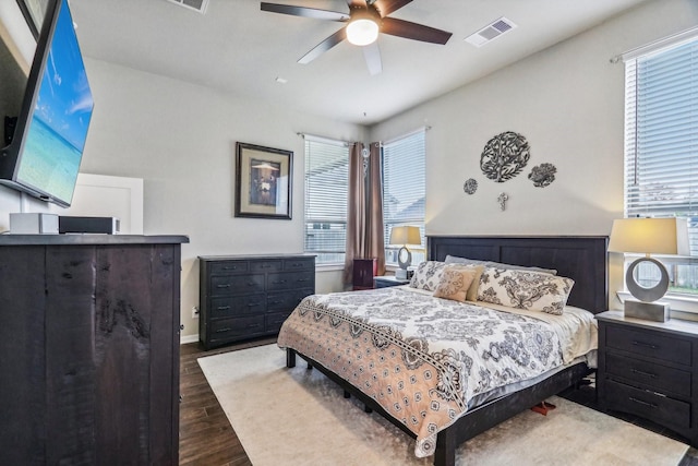 bedroom with dark hardwood / wood-style floors and ceiling fan