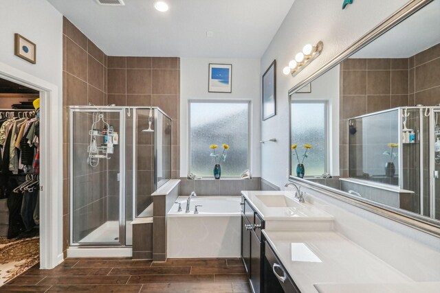 bathroom with shower with separate bathtub and vanity