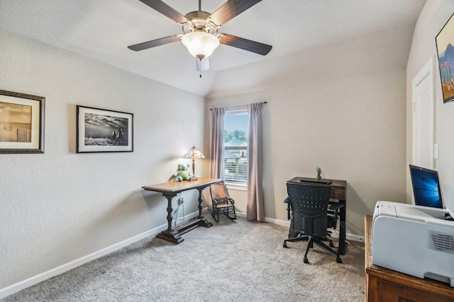 home office featuring carpet, ceiling fan, and vaulted ceiling