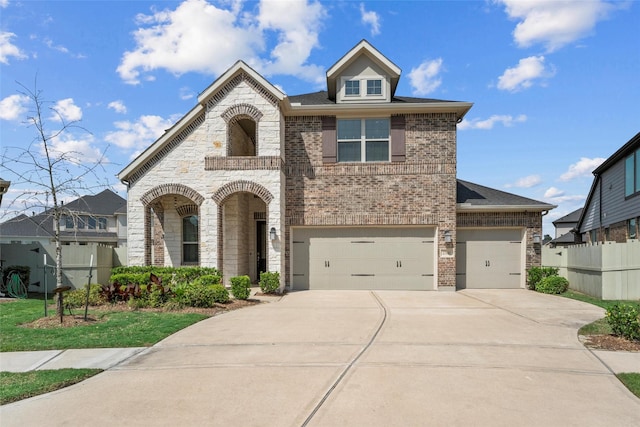 17040 Shy Leaf Ct, Conroe, TX 77385 - french country home with concrete driveway, brick siding, fence, and stone siding