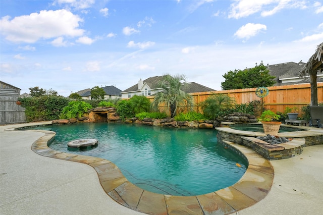 view of pool featuring an in ground hot tub and a patio