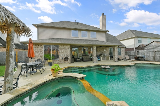 view of pool featuring ceiling fan, a patio area, an in ground hot tub, and grilling area