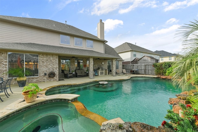 view of swimming pool with an in ground hot tub, a patio, and ceiling fan