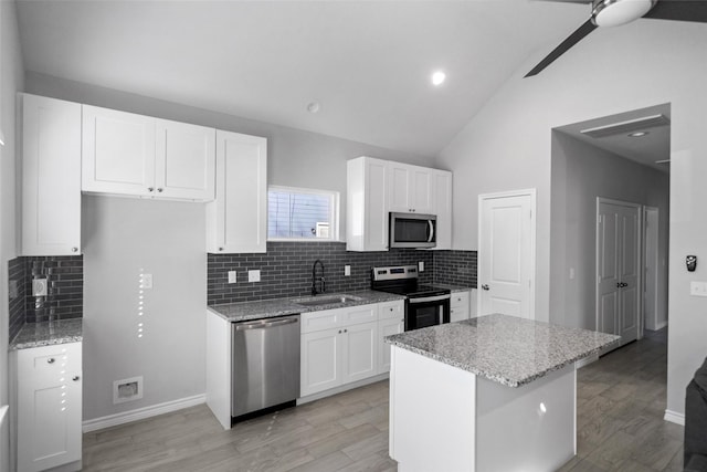 kitchen with white cabinets, sink, light wood-type flooring, and stainless steel appliances